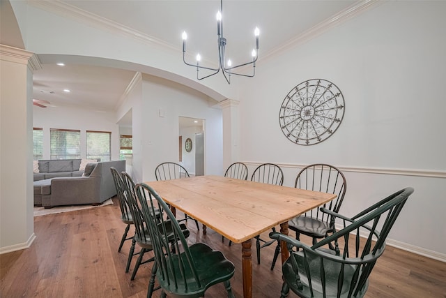 14311 Cally Cir, Needville, TX 77461 - dining space featuring crown molding, arched walkways, light wood-style floors, a chandelier, and recessed lighting
