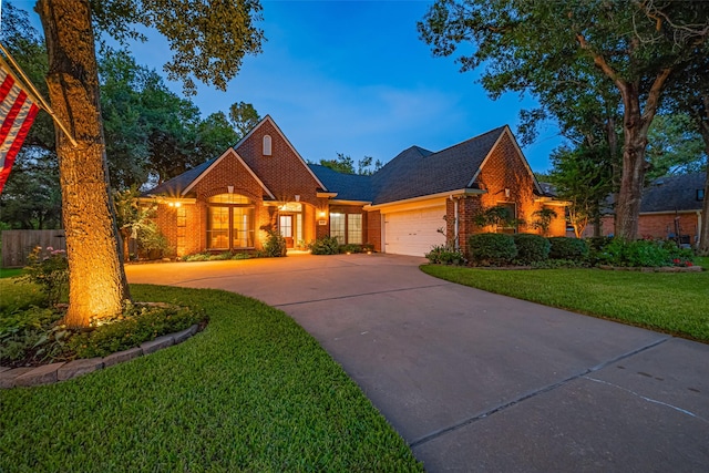 14311 Cally Cir, Needville, TX 77461 - view of front facade with brick siding, driveway, an attached garage, and roof with shingles