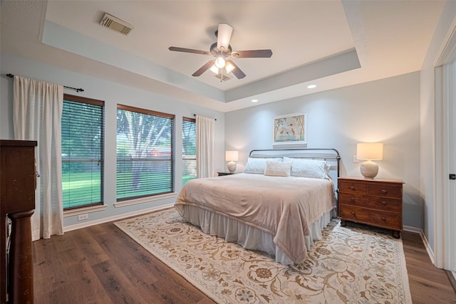 14311 Cally Cir, Needville, TX 77461 - bedroom featuring a tray ceiling, wood finished floors, a ceiling fan, and recessed lighting