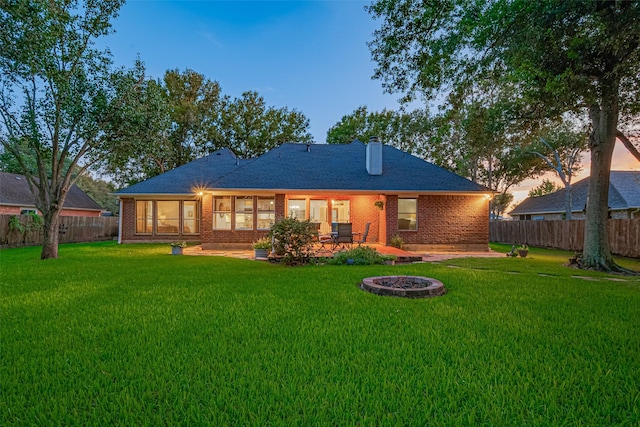 14311 Cally Cir, Needville, TX 77461 - rear view of property featuring a fenced backyard, brick siding, a patio area, and a chimney