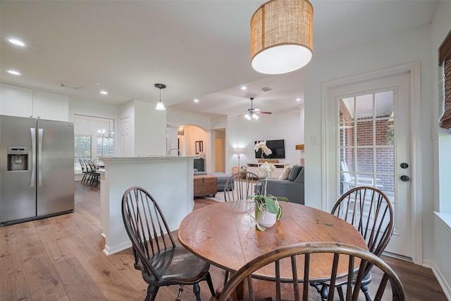 14311 Cally Cir, Needville, TX 77461 - dining area with arched walkways, light wood-type flooring, a ceiling fan, and recessed lighting