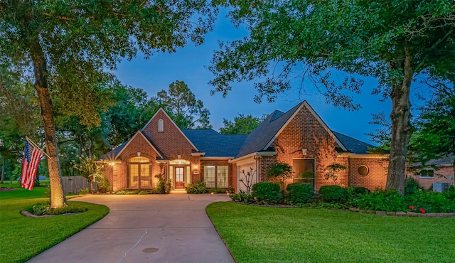 14311 Cally Cir, Needville, TX 77461 - view of front of property with concrete driveway, brick siding, a front lawn, and a garage
