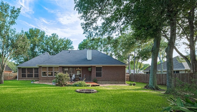 14311 Cally Cir, Needville, TX 77461 - rear view of property with a fenced backyard, a fire pit, a patio, and brick siding