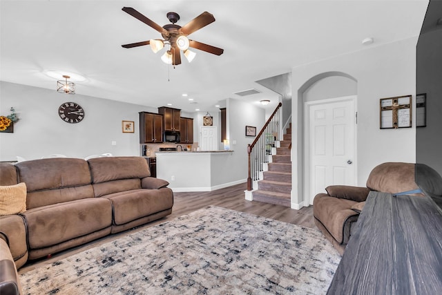 10211 Norway Spruce Ln, Tomball, TX 77375 - living area with a ceiling fan, wood finished floors, stairway, arched walkways, and recessed lighting
