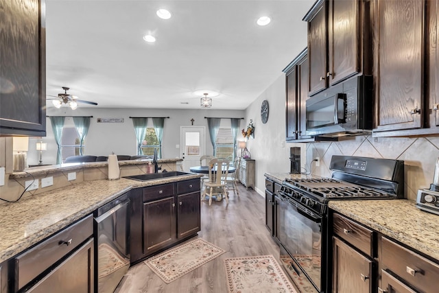 10211 Norway Spruce Ln, Tomball, TX 77375 - kitchen featuring black appliances, tasteful backsplash, dark brown cabinetry, light stone countertops, and recessed lighting