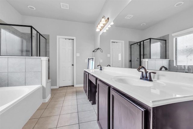 10211 Norway Spruce Ln, Tomball, TX 77375 - bathroom with double vanity, a shower stall, a garden tub, and tile patterned floors