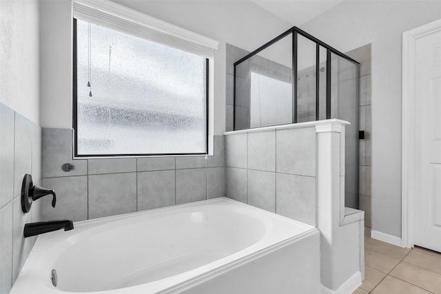 10211 Norway Spruce Ln, Tomball, TX 77375 - full bathroom with healthy amount of natural light, a bath, a shower stall, and tile patterned floors