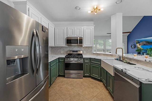 6006 Gilman Trace Ln, Houston, TX 77092 - kitchen featuring appliances with stainless steel finishes, green cabinets, and white cabinetry