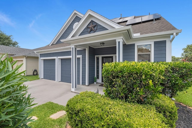 6006 Gilman Trace Ln, Houston, TX 77092 - view of front of home with an attached garage, driveway, roof mounted solar panels, and roof with shingles