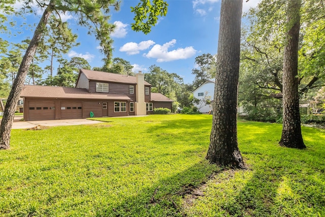 6415 Bayonne Dr, Spring, TX 77389 - view of grassy yard featuring a garage and driveway