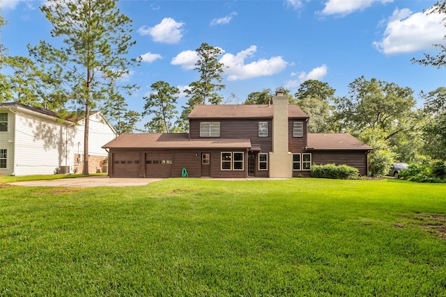 6415 Bayonne Dr, Spring, TX 77389 - back of house with a chimney, an attached garage, a yard, concrete driveway, and roof with shingles