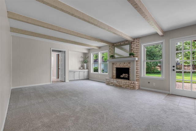6415 Bayonne Dr, Spring, TX 77389 - unfurnished living room with healthy amount of natural light, beam ceiling, a fireplace, and carpet floors