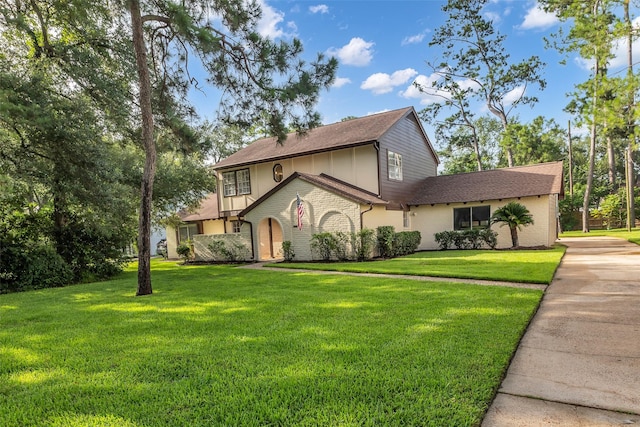 6415 Bayonne Dr, Spring, TX 77389 - view of front facade featuring a front yard, brick siding, and concrete driveway