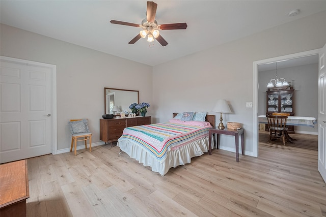 12118 Dumas St, Houston, TX 77034 - bedroom with light wood-style floors, a chandelier, and a ceiling fan