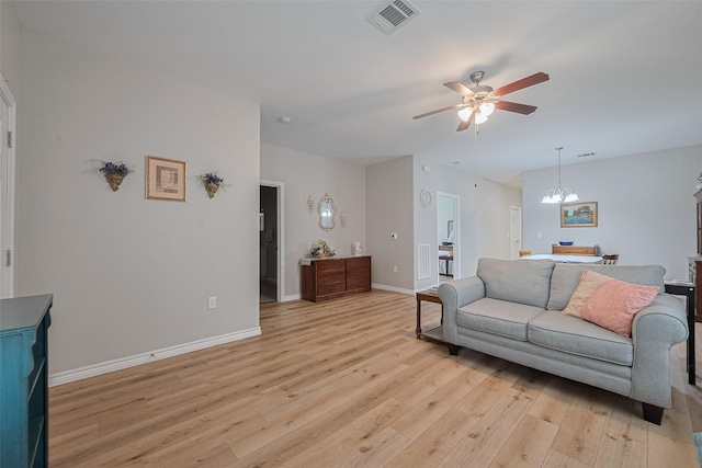 12118 Dumas St, Houston, TX 77034 - living room with a ceiling fan, light wood-style floors, and a chandelier