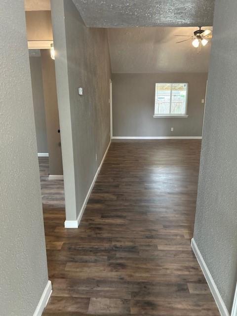 15834 Bazelbriar Ln, Houston, TX 77489 - empty room featuring a textured wall, wood finished floors, and a ceiling fan