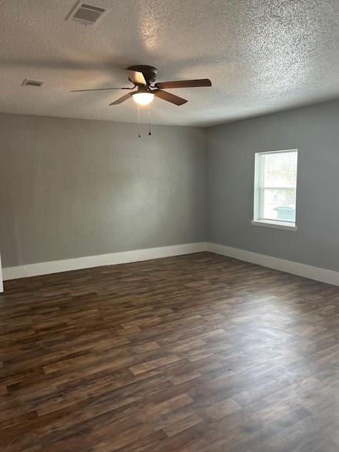 15834 Bazelbriar Ln, Houston, TX 77489 - spare room featuring dark wood-type flooring, a ceiling fan, and a textured ceiling