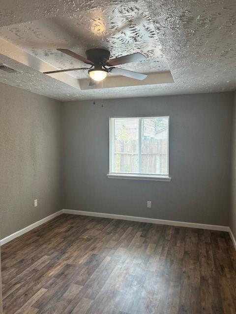 15834 Bazelbriar Ln, Houston, TX 77489 - spare room with ceiling fan, dark wood-style floors, and a textured ceiling