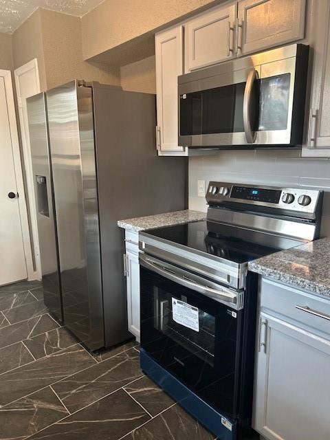 15834 Bazelbriar Ln, Houston, TX 77489 - kitchen with stainless steel appliances, dark marble finish floors, and stone counters