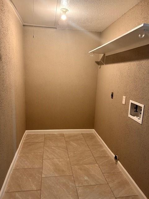 15834 Bazelbriar Ln, Houston, TX 77489 - washroom with washer hookup, electric dryer hookup, attic access, light tile patterned flooring, and a textured ceiling