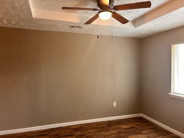 15834 Bazelbriar Ln, Houston, TX 77489 - spare room featuring dark wood-type flooring, a ceiling fan, and a textured ceiling