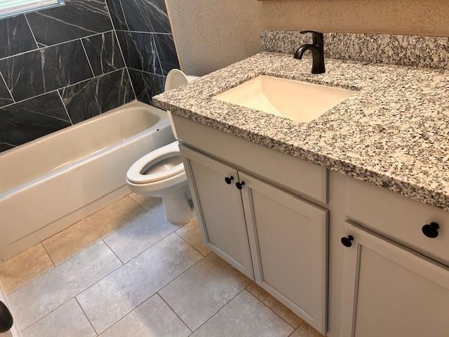 15834 Bazelbriar Ln, Houston, TX 77489 - full bathroom with vanity,  shower combination, and tile patterned flooring