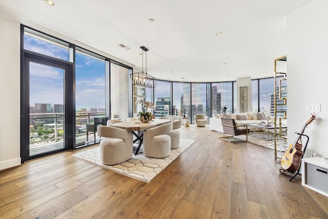 1409 Post Oak Blvd Unit 2204, Houston, TX 77056 - dining room featuring floor to ceiling windows, wood-type flooring, and a city view