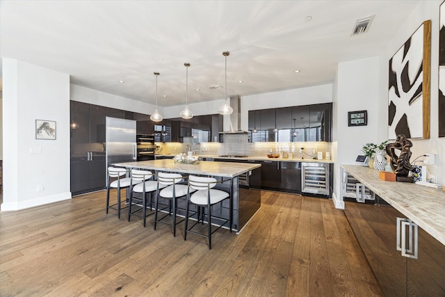 1409 Post Oak Blvd Unit 2204, Houston, TX 77056 - kitchen with beverage cooler, a kitchen bar, wall chimney range hood, modern cabinets, and backsplash