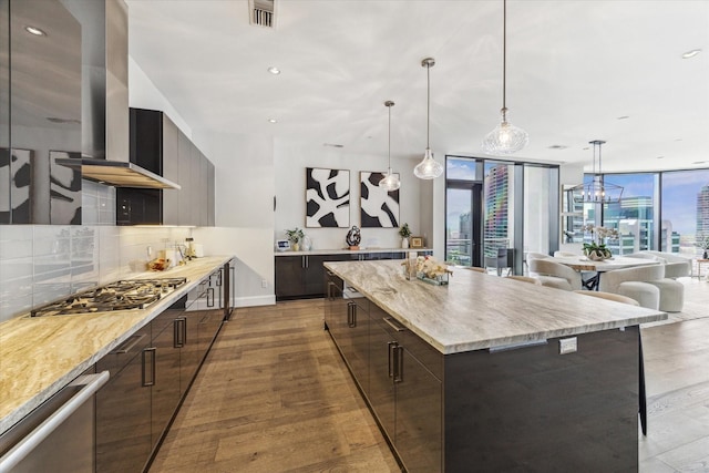 1409 Post Oak Blvd Unit 2204, Houston, TX 77056 - kitchen featuring modern cabinets, stainless steel gas stovetop, tasteful backsplash, light wood finished floors, and recessed lighting