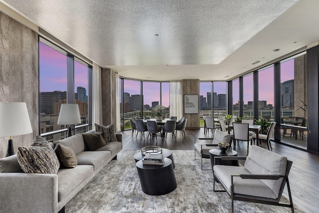 1409 Post Oak Blvd Unit 2204, Houston, TX 77056 - living room featuring floor to ceiling windows, a view of skyline, wood finished floors, and a textured ceiling