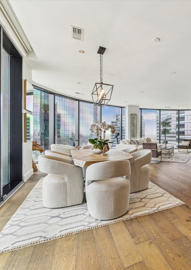 1409 Post Oak Blvd Unit 2204, Houston, TX 77056 - living room featuring a chandelier, floor to ceiling windows, and wood finished floors