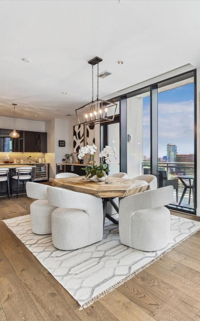 1409 Post Oak Blvd Unit 2204, Houston, TX 77056 - dining area featuring hardwood / wood-style floors, a chandelier, and floor to ceiling windows