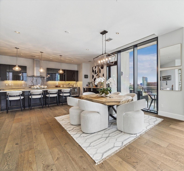 1409 Post Oak Blvd Unit 2204, Houston, TX 77056 - dining area featuring hardwood / wood-style floors, a chandelier, and floor to ceiling windows