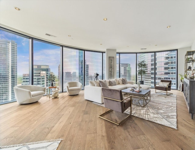 1409 Post Oak Blvd Unit 2204, Houston, TX 77056 - living room featuring wood-type flooring, a city view, floor to ceiling windows, and plenty of natural light