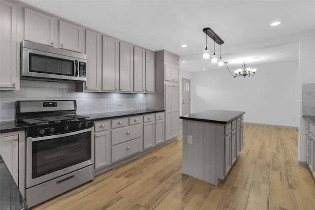 2934 Robertson St, Houston, TX 77009 - kitchen with appliances with stainless steel finishes, dark countertops, gray cabinets, and recessed lighting