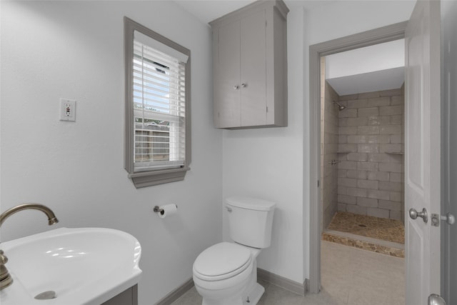 2934 Robertson St, Houston, TX 77009 - bathroom featuring tiled shower, vanity, and tile patterned flooring