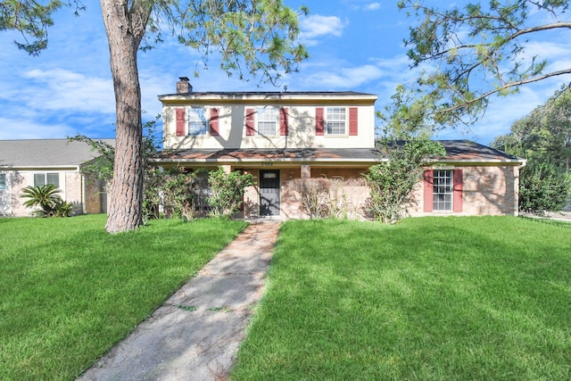3502 Quail Meadow Dr, Missouri City, TX 77459 - view of front of house with a front yard and a chimney