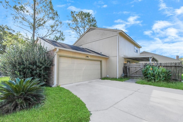 3502 Quail Meadow Dr, Missouri City, TX 77459 - view of side of home with driveway, a garage, and a gate