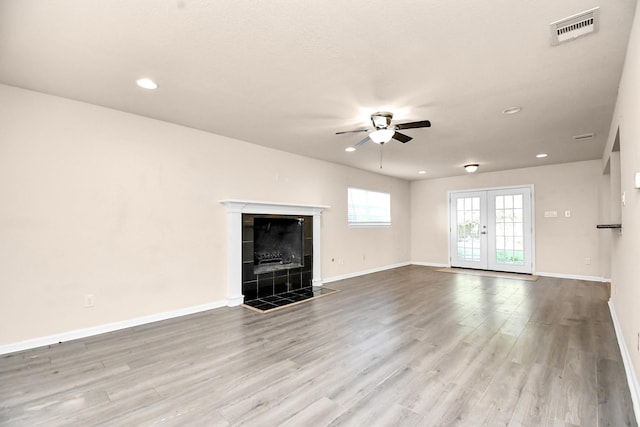 3502 Quail Meadow Dr, Missouri City, TX 77459 - unfurnished living room with a ceiling fan, wood finished floors, french doors, recessed lighting, and a tiled fireplace