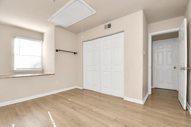 3502 Quail Meadow Dr, Missouri City, TX 77459 - unfurnished bedroom featuring attic access, light wood finished floors, and a closet