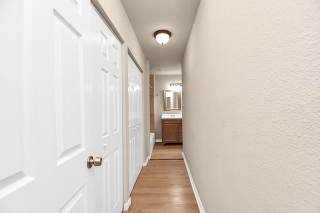 3502 Quail Meadow Dr, Missouri City, TX 77459 - corridor with baseboards and light wood-type flooring
