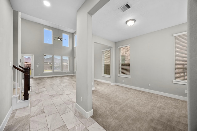 13207 Terania Cliff Trce, Houston, TX 77059 - foyer featuring a ceiling fan, light carpet, light marble finish flooring, and stairs