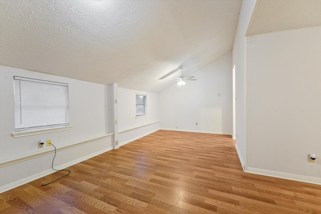 4790 Whispering Falls Dr, Houston, TX 77084 - additional living space with light wood-type flooring, a ceiling fan, vaulted ceiling, and a textured ceiling