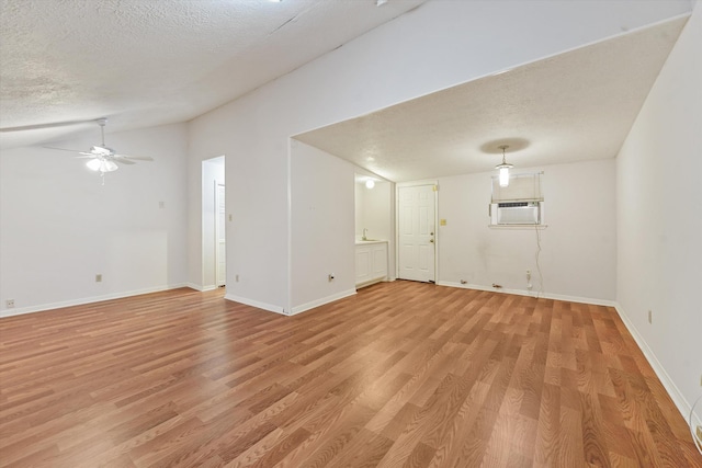 4790 Whispering Falls Dr, Houston, TX 77084 - spare room featuring lofted ceiling, a textured ceiling, light wood-style floors, and a ceiling fan