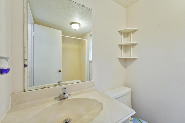 4790 Whispering Falls Dr, Houston, TX 77084 - bathroom featuring a textured ceiling and vanity
