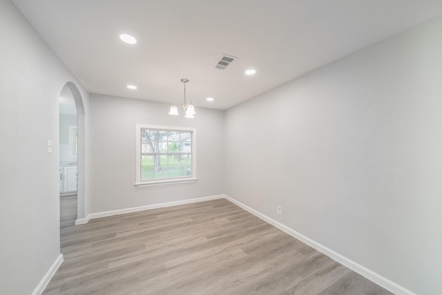 6307 Westover St, Houston, TX 77087 - empty room with arched walkways, light wood-type flooring, a chandelier, and recessed lighting