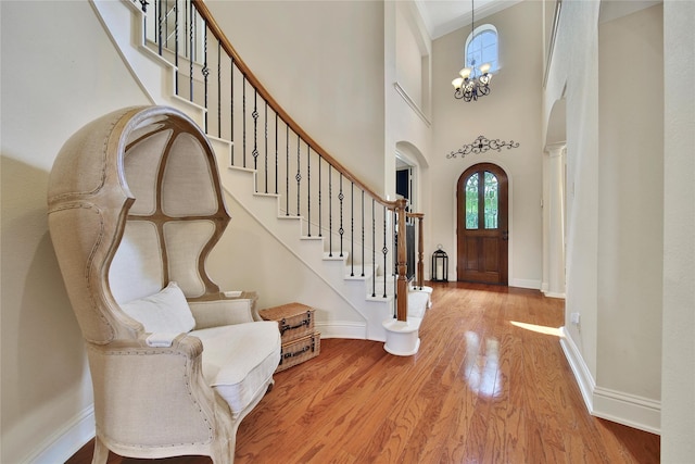5714 Spring River Ln, Fulshear, TX 77441 - foyer entrance with arched walkways, wood finished floors, stairway, a towering ceiling, and crown molding