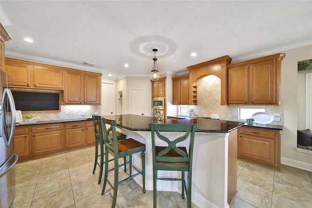 5714 Spring River Ln, Fulshear, TX 77441 - kitchen with appliances with stainless steel finishes, recessed lighting, a center island with sink, tasteful backsplash, and a breakfast bar