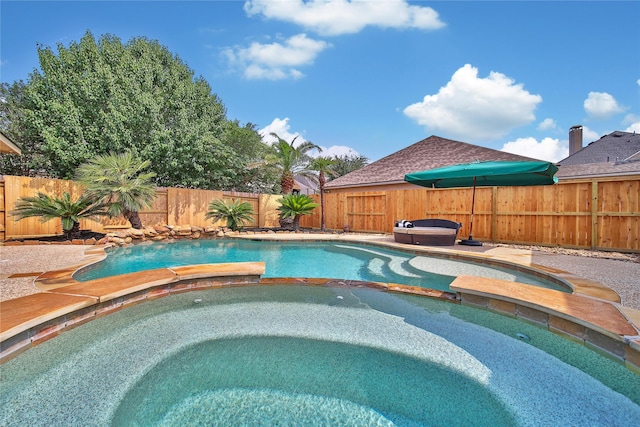 5714 Spring River Ln, Fulshear, TX 77441 - view of swimming pool with a pool with connected hot tub and a fenced backyard