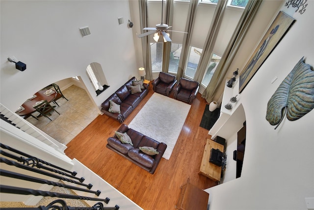 5714 Spring River Ln, Fulshear, TX 77441 - living area with a high ceiling, arched walkways, and a ceiling fan